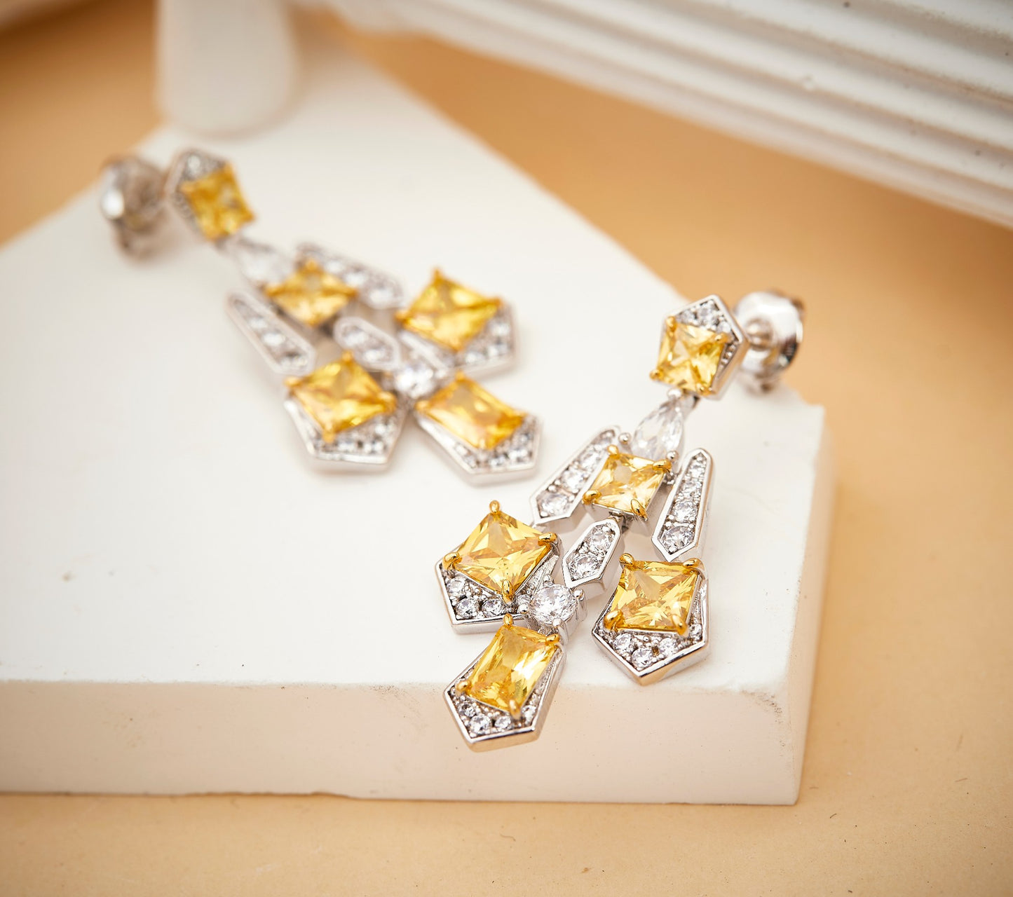 Pair of solar cross drop earrings with yellow gemstone cross design