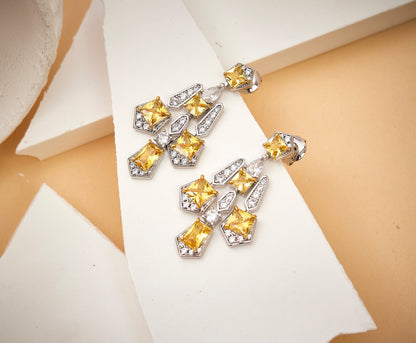 Close-up detail of solar cross drop earrings showing gothic geometric design