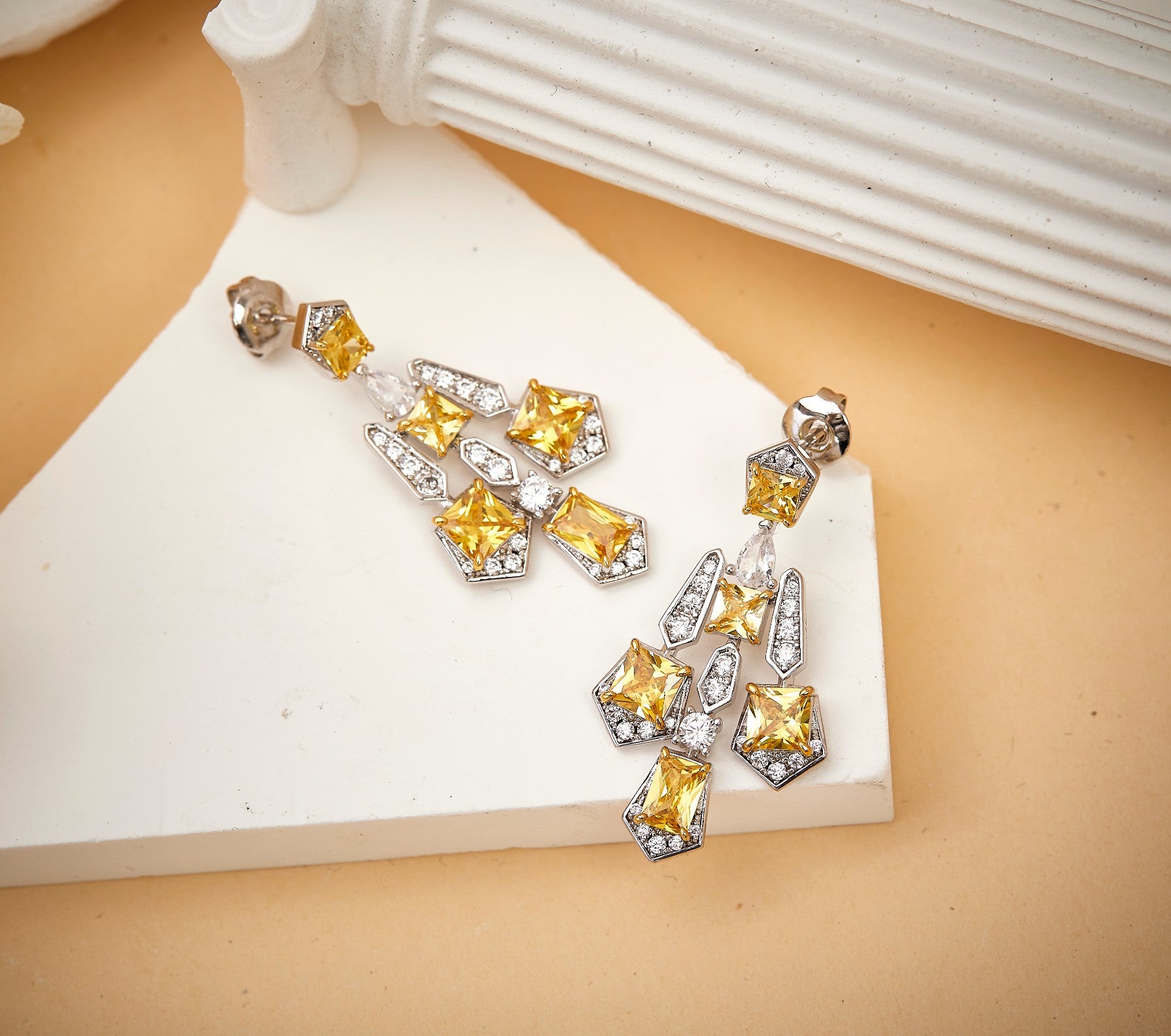 Close-up detail of solar cross drop earrings showing gothic geometric design