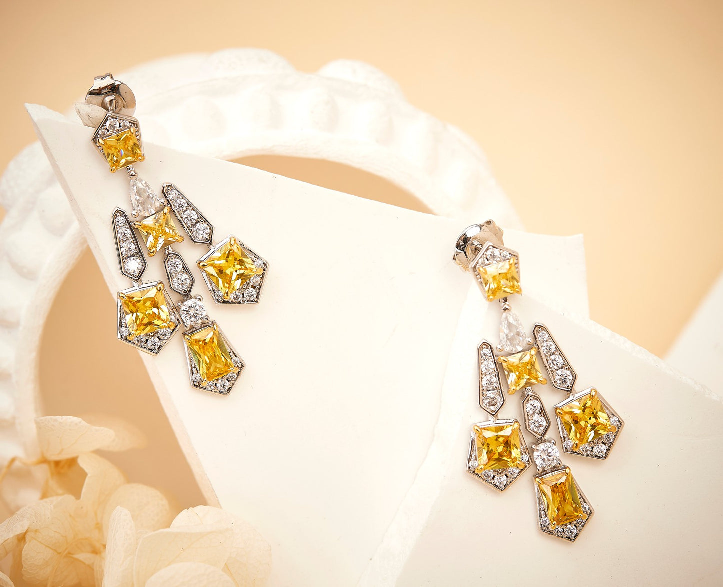 Solar cross drop earrings worn on model showing length and fit