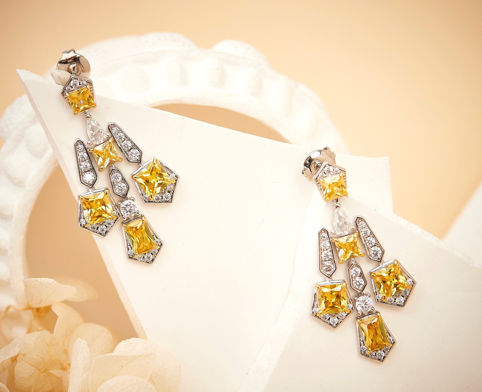 Solar cross drop earrings worn on model showing length and fit