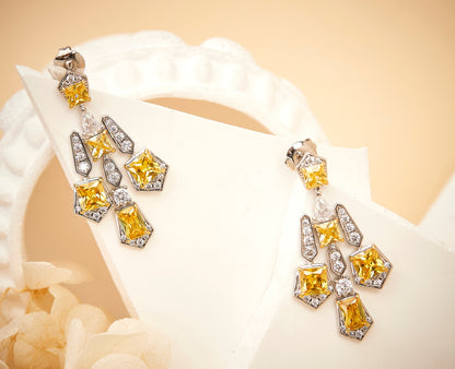 Solar cross drop earrings worn on model showing length and fit